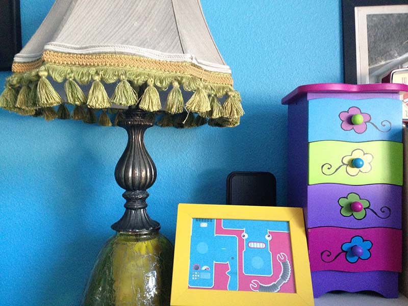 Male's ugly lamp, framed robot picture and chest of drawers from Goodwill.